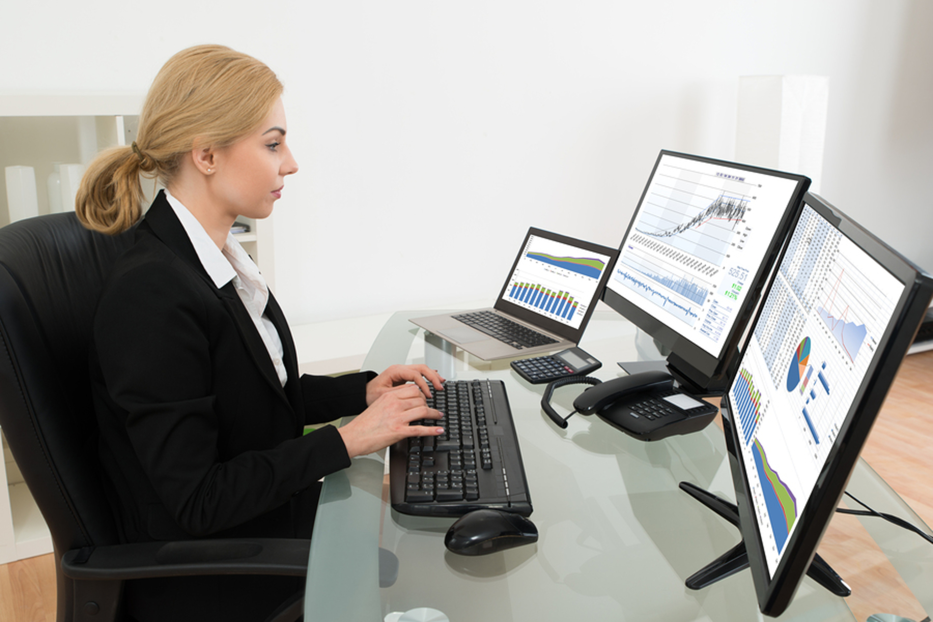 Woman typing on a desktop computer keyboard.